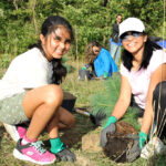 http://Young%20girl%20and%20mom%20planting%20tree.