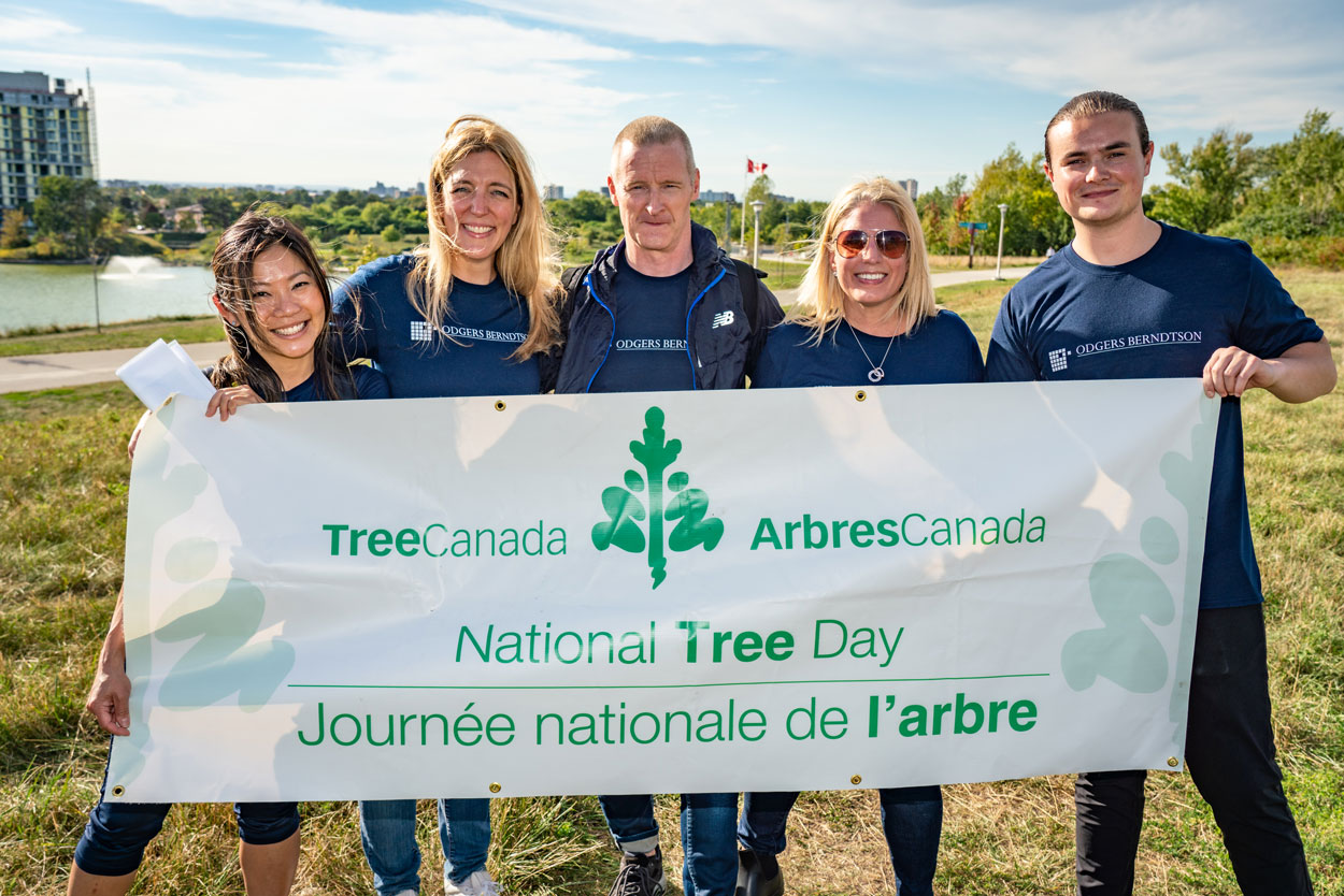 Sponsor volunteers posing with the National Tree Day banner.